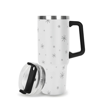 White travel mug with black star pattern and black handle on a white background