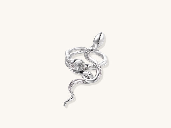 Gold-plated brass snake ring with flowing curves and crystal accents, wrapping around finger in sculptural design