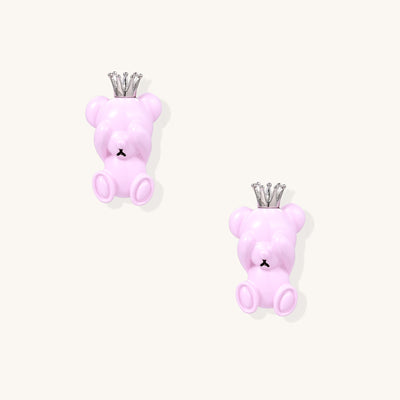 Pair of pink teddy bear-shaped stud earrings with silver crowns on white background, made from gold-plated brass