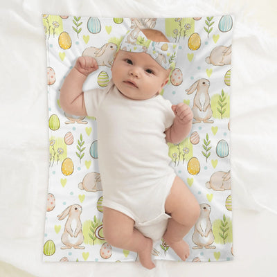Baby lying on a personalized Easter bunny blanket with a matching headband | Our Phoenix Rise