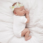 Sleeping baby wearing a personalized Easter bunny headband on a white blanket | Our Phoenix Rise