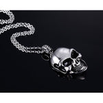 Polished Skull Pendant Necklace - Side View Lying Flat On Reflective Surface | Our Phoenix Rise