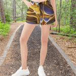 Liquid Gold Athletic Shorts - Fabric texture and stretch detail | Our Phoenix Rise