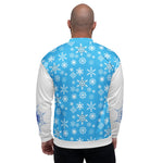 Back view of a man wearing a light blue jacket covered in white snowflakes, with solid white sleeves.
