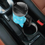 Blue mug with snowflake pattern in a car cup holder