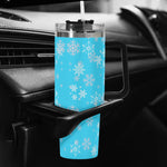 Blue tumbler with snowflake pattern in a car cup holder