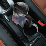Character Car cup holder with a clear mug and black handle on a car's console.