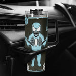 Clear tumbler with a blue and black character design on a car cup holder.
