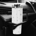 Clear tumbler with star pattern on a car cup holder