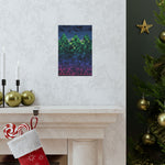 Decorative abstract painting on a wall above a fireplace with Christmas stockings and tree.