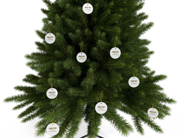 Green Christmas tree with decorative tags on a white background