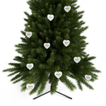 Green Christmas tree with heart-shaped white ornaments on a white background