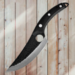 Large knife with a black handle on a wooden background