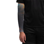 Person wearing a black sleeve with a colorful tattoo design on a white background