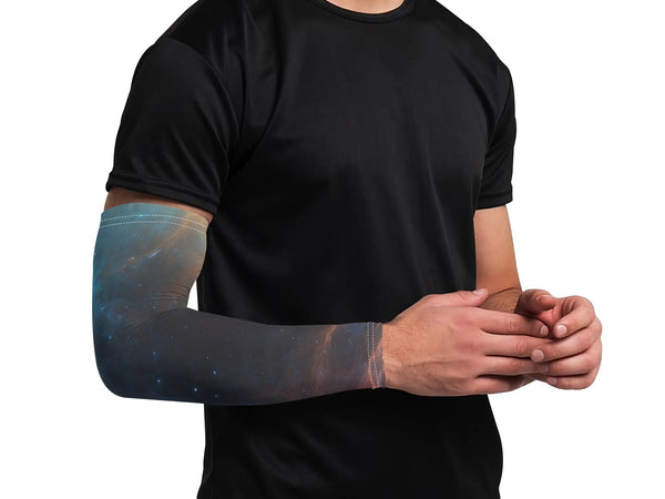 Person wearing a black t-shirt with a galaxy-themed arm sleeve on a white background