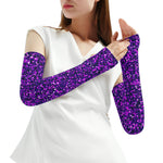 Person wearing purple glittery arm sleeves on a white background
