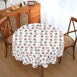 Round table with a decorative tablecloth featuring animal patterns in a home setting.