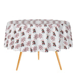 Round table with a festive tablecloth featuring snowmen and snowflakes on a white background