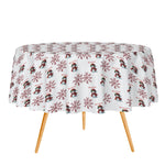 Round table with a festive tablecloth featuring snowmen and snowflakes on a white background