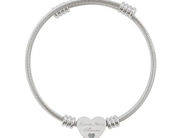 Silver tone adjustable cable cuff bangle bracelet with personalized heart charm engraving. Hypoallergenic stainless steel jewelry gift for her.