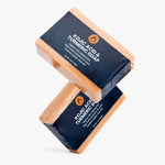 Two bars of Kojic Acid Turmeric Soap on a white background