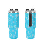 Two blue tumblers with snowflake patterns on a white background