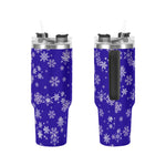 Two blue tumblers with white snowflake patterns on a white background