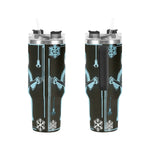 Two insulated tumblers with a winter-themed design on a white background