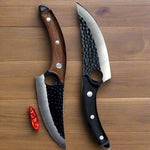 Two knives with black and brown handles on a beige table