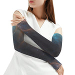 Woman wearing a white top with galaxy-themed arm sleeves on a white background