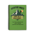 Green notebook with mountain design and text 'Adventure Awaits, Love is a Wild Ride!' on a white background