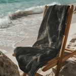 Gothic Skull Beach Towel - Folded on Wooden Beach Chair | Our Phoenix Rise