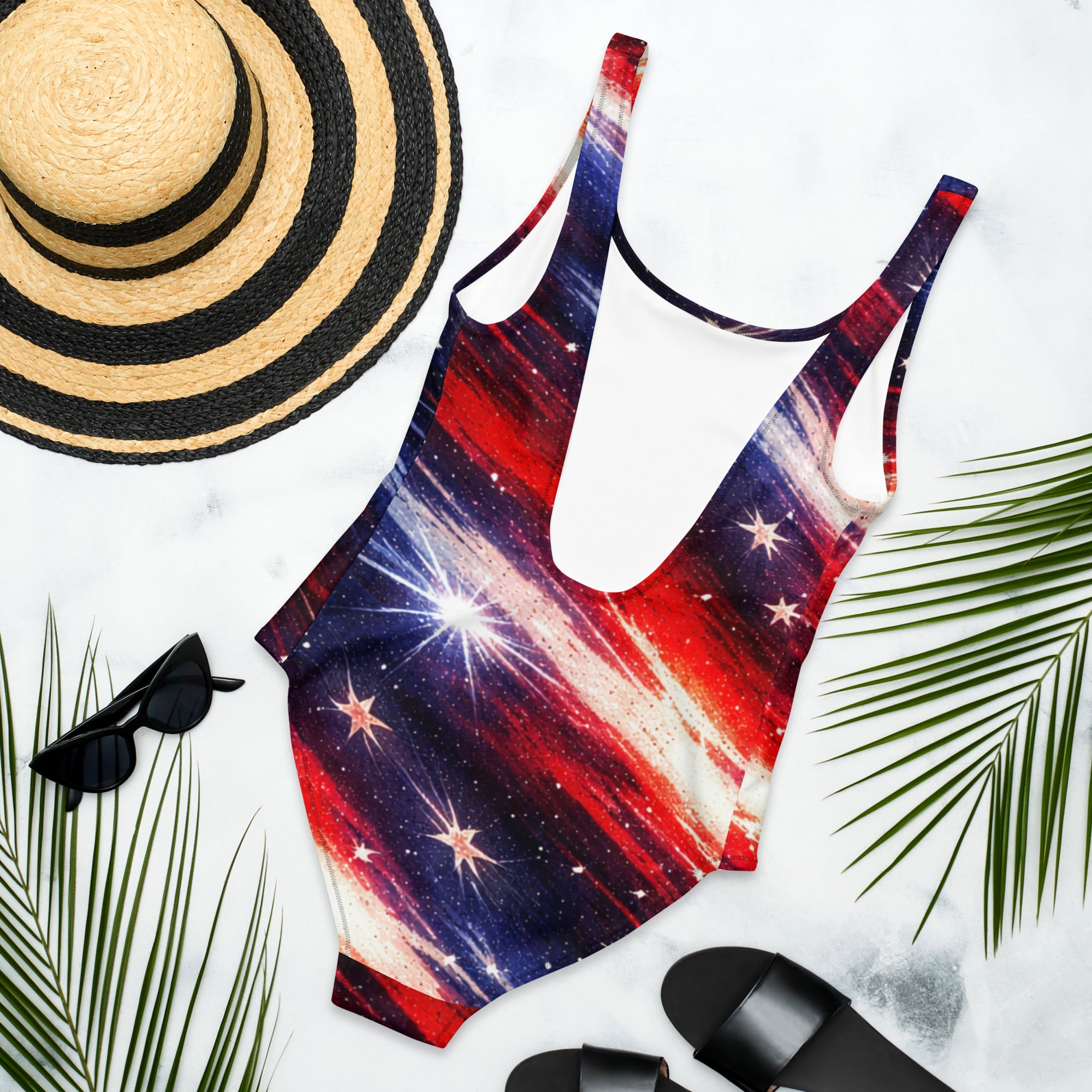 Americana Flag One Piece Swimsuit - Back view flat lay with straw hat and palm leaves | Our Phoenix Rise