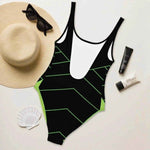 Black Neon Green One Piece Swimsuit - Woman on beach, side profile | Our Phoenix Rise