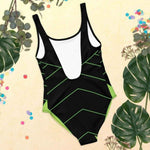 Black Neon Green One Piece Swimsuit - Woman on beach, back profile | Our Phoenix Rise
