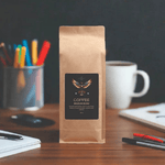 Fair Trade Brazilian Blend Coffee 16oz - Dark background, illuminated | Our Phoenix Rise