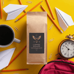 Fair Trade Brazilian Blend Coffee 16oz - On wooden surface, bokeh lights | Our Phoenix Rise