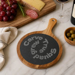 Personalized Acacia Slate Charcuterie Board - Hand selecting cheese from an oval engraved serving board at a gathering | Our Phoenix Rise