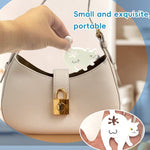 Cat Butt Shaped Food Sealing Clip - Hand holding the compact white clip over a handbag for scale | Our Phoenix Rise
