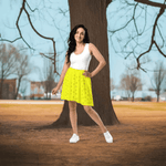 Yellow Leaf Print Skater Skirt - Woman in yellow mini skirt side view | Our Phoenix Rise