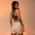 Model in black high impact longline sports bra, dynamic back pose | Our Phoenix Rise
