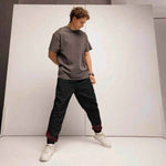 Black Flame Water Resistant Track Pants - model in active pose | Our Phoenix Rise