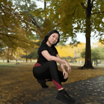 Maroon Black Crossover Leggings with Pockets - Model stretching, showing flexibility | Our Phoenix Rise