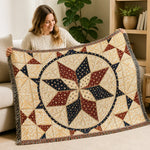 Beige quilt with red and navy star pattern held by woman sitting on sofa | Our Phoenix Rise