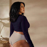Soaring Bird Cropped Rash Guard Women's UPF 50+ - Woman standing in gym with deep violet cropped rash guard lifting dumbbells | Our Phoenix Rise
