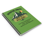 Closed spiral notebook lying flat on a surface. Shows the vibrant adventure-themed cover design and durable metal wire binding from a high angle.