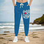 Blue Surfer Print Joggers - Man wearing joggers on beach | Our Phoenix Rise
