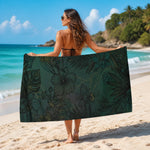 dark green hibiscus tropical beach towel - couple relaxing on beach | Our Phoenix Rise