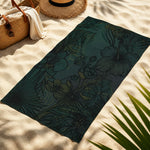 dark green hibiscus tropical beach towel - on a wooden beach chair by the ocean | Our Phoenix Rise