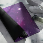 Purple galaxy pattern yoga mat partially rolled showing black underside | Our Phoenix Rise